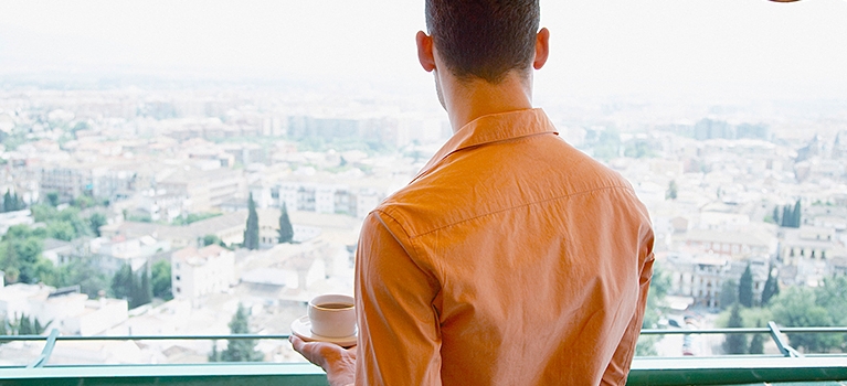 Man drinking espresso and enjoying view