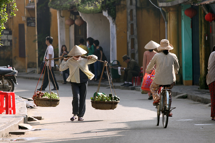 Locals walking and biking in street Locals walking and biking in street